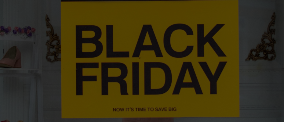 Black Friday sale sign displaying a bold '50% off' discount in yellow and black, promoting savings and discounts.