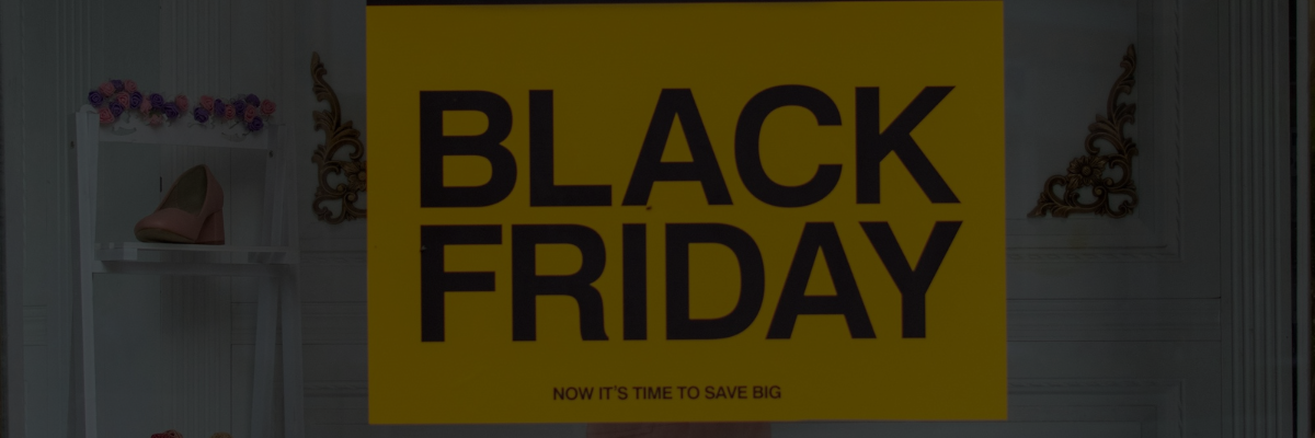 Black Friday sale sign displaying a bold '50% off' discount in yellow and black, promoting savings and discounts.
