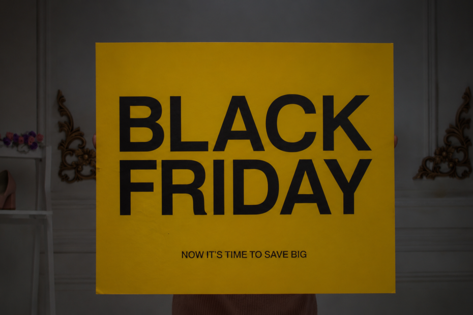 Black Friday sale sign displaying a bold '50% off' discount in yellow and black, promoting savings and discounts.